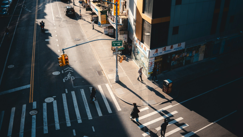 City intersection with crosswalk and buildings.