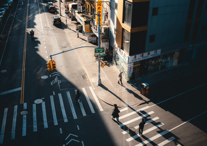 City intersection with crosswalk and buildings.
