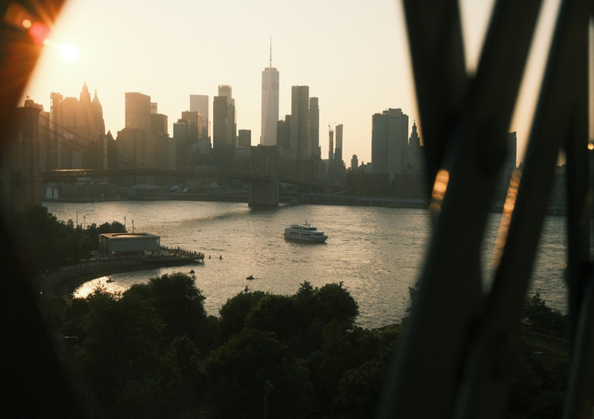 New york city skyline seen across the water at sunset.